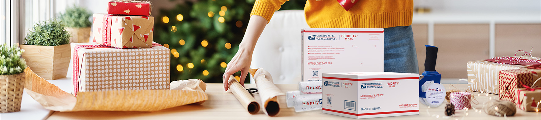 Person wrapping holiday gifts to ship using Priority Mail boxes and ReadyPost supplies.